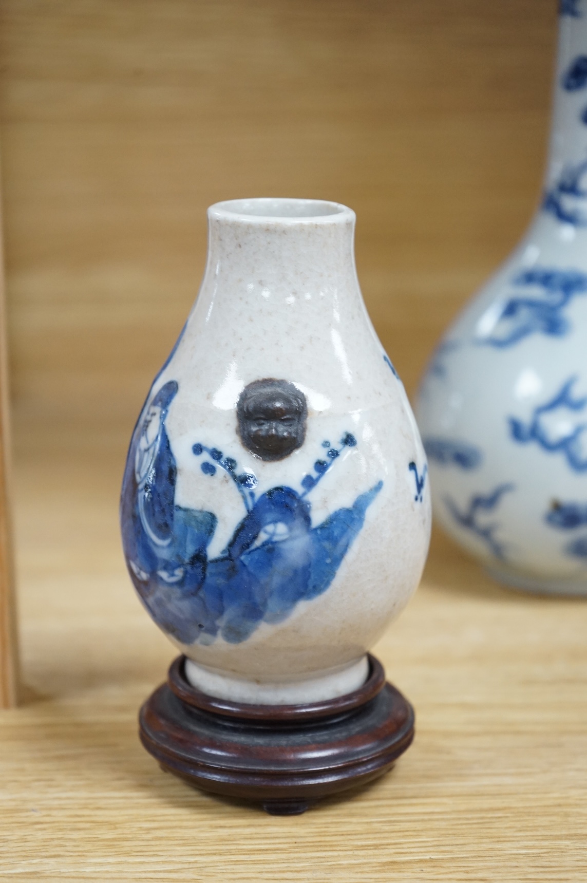 A Chinese blue and white bottle vase, a crackle glaze vase and a Tibetan copper and brass ‘monk’ cap’ ewer (3), tallest 21cm